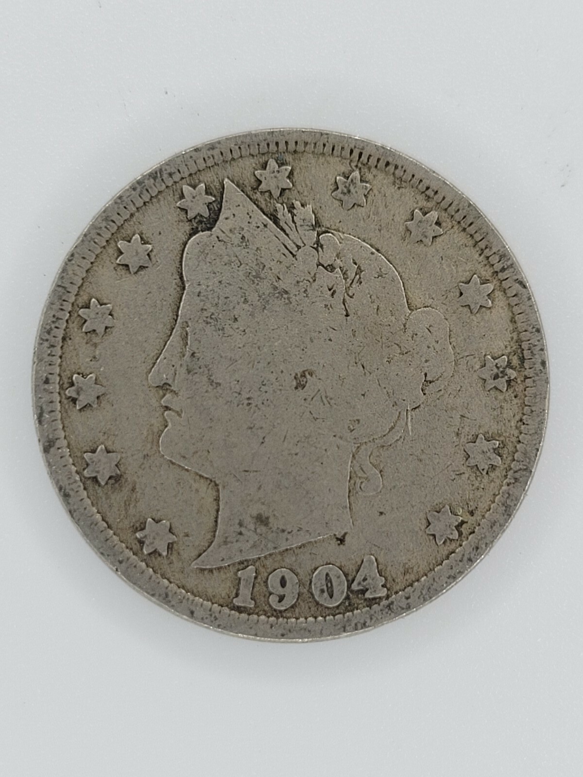 1904 Liberty Head Nickel strike-through error showing impression of a foreign object in the coin surface